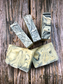 Handmade Patchouli and Sweet Orange soap bar by Madaboutnature, showing its natural, textured surface and vibrant orange color.