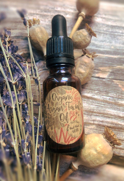 Organic Argan facial oil from Madaboutnature, featuring a clear glass bottle with dropper for skincare application.