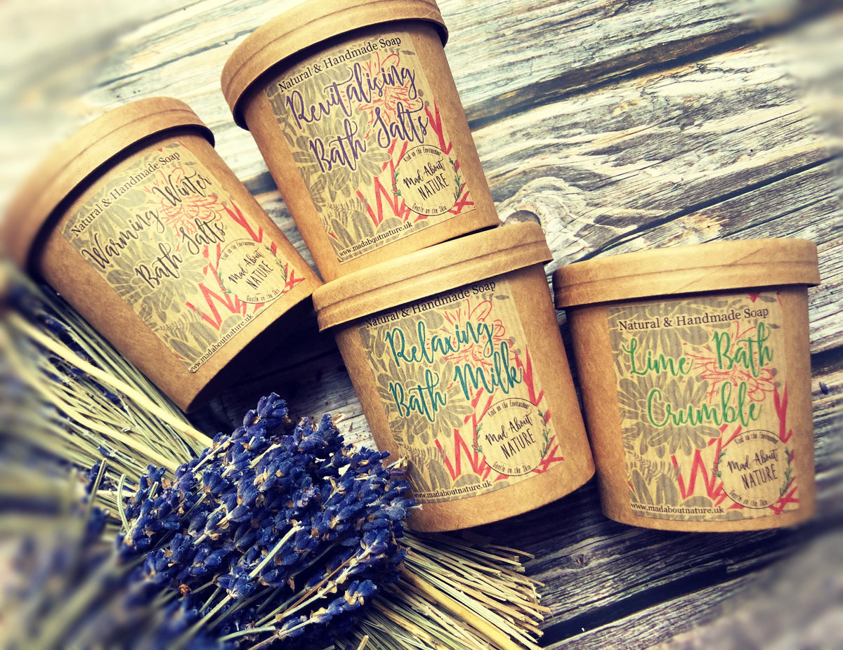 Relaxing bath milk with lavender and geranium in a glass bottle, surrounded by fresh lavender and geranium flowers.