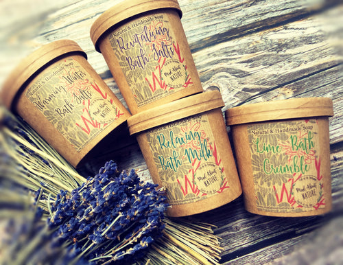 Relaxing bath milk with lavender and geranium in a glass bottle, surrounded by fresh lavender and geranium flowers.